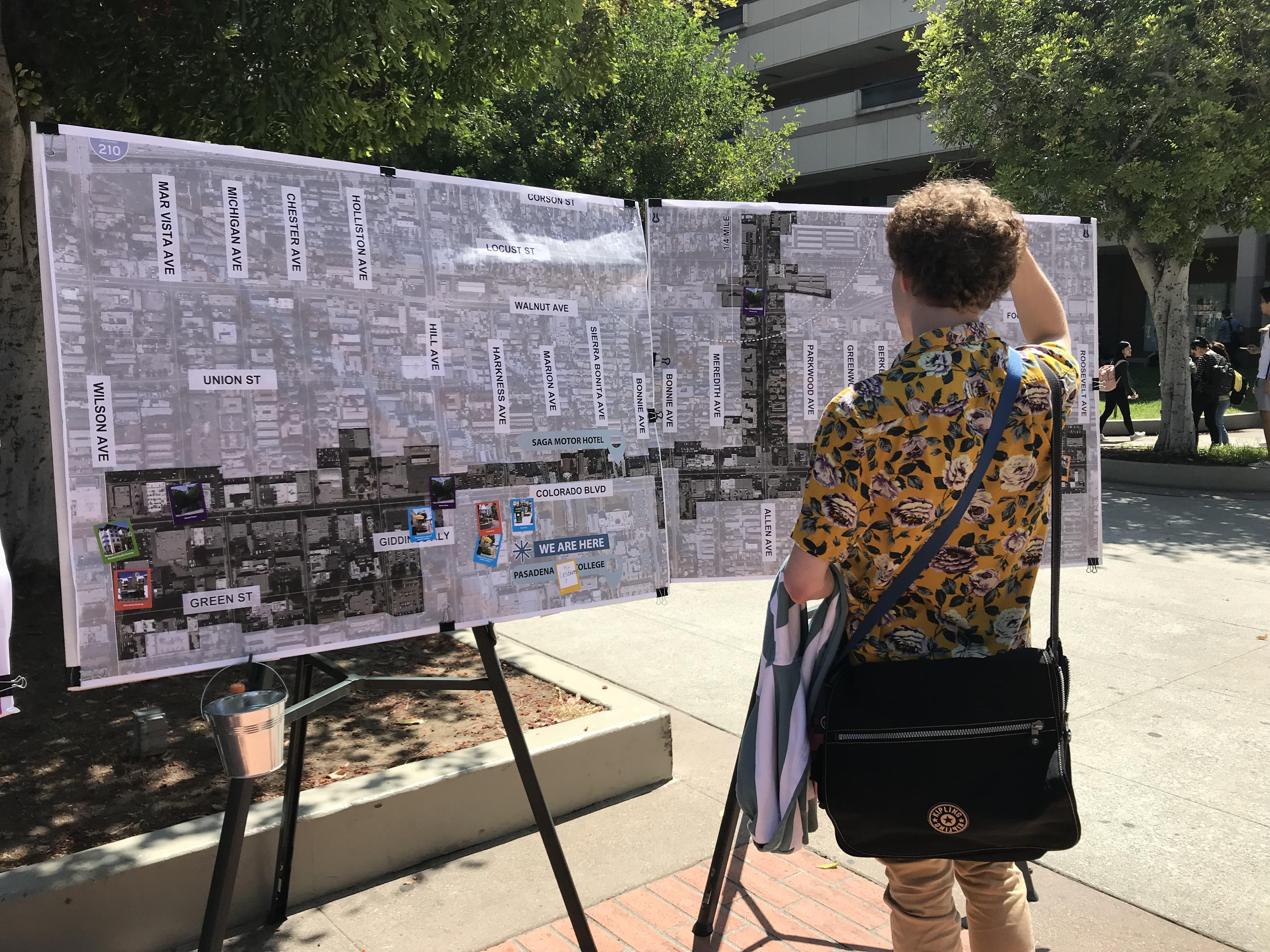 A passerby viewing a pop-up display at Pasadena City College