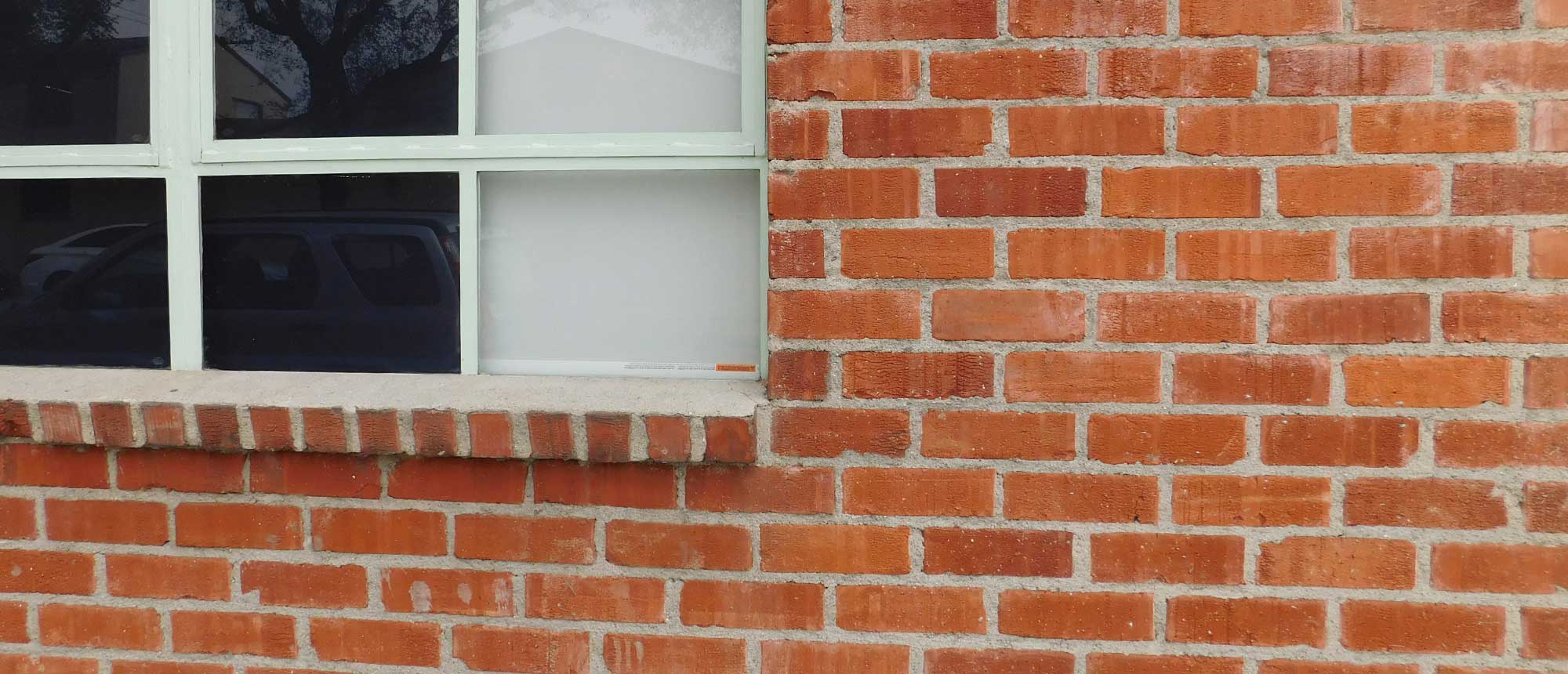 A brick wall and window of a building 